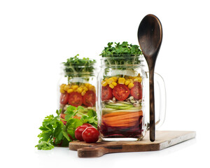 Healthy homemade salad with fresh vegetables and sprouts in glass jars on a white background.. Healthy food, diet, detox, clean food, vegetarian concept.