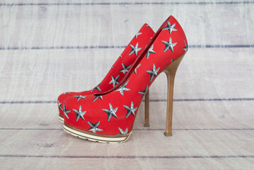  womens high-heeled shoes on a wooden background.