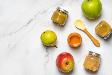 Healthy baby food. Flat lay composition with mashed in glass jars and fruits. First feeding.