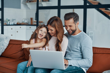 Young beautiful family with little girl bonding together 