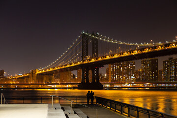 Manhattan Bridge at night, with a viewing platform on Brooklyn side, New York, USA.