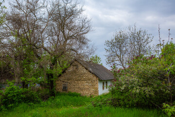 Obraz premium landscape with old, forgotten house, abandoned somewhere in the villages of Moldova. Abandoned house in Republic of Moldova. Depopulation concept.
