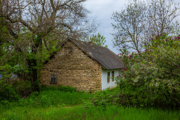 Fototapeta na wymiar landscape with old, forgotten house, abandoned somewhere in the villages of Moldova. Abandoned house in Republic of Moldova. Depopulation concept.