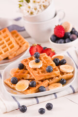 Waffles with blueberries, bananas and honey.