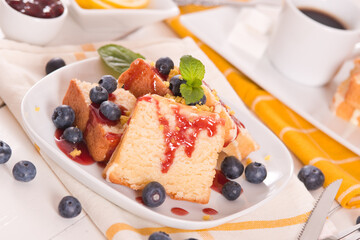 Lemon pund cake with blueberries and strawberry syrup.