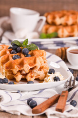 Waffles with blueberries and whipped cream.