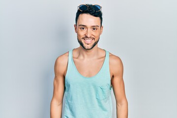 Young hispanic man wearing summer style with a happy and cool smile on face. lucky person.