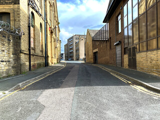 Road leading into, Little Germany, with Victorian stone built warehouses, built for the textile industry in, Bradford, Yorkshire, UK