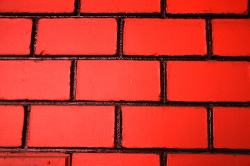 New red colour wall of bricks and cement of home. good background texture