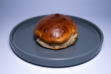 Homemade burger bread. Organic hamburger bread. Close-up home bread on the gray plate.