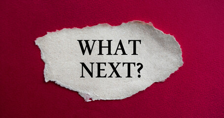 The inscription WHAT NEXT on torn paper. Marketing conceptual word on red background.
