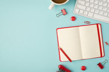 Top view photo of open red reminder binders pins clips stapler cup of coffee and keyboard on...