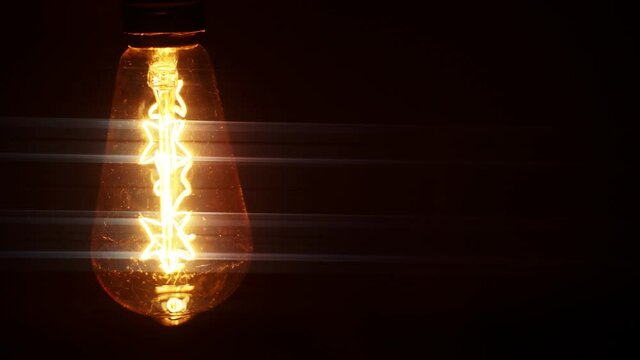 The light turns on. Edison light bulb reproduction.