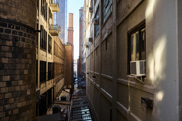 Industrial back alley with brick chimney in background