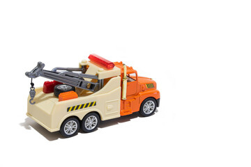 Toy tow truck on a white background. Children's car for transporting cars.