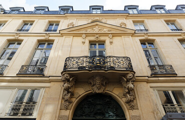 Traditional French house with typical balconies and windows. Paris.