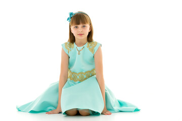 The little girl is on her knees.Isolated on a white background.