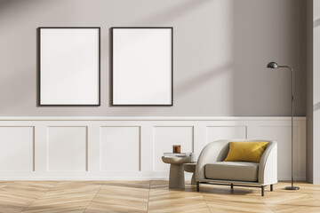 Modern living room interior with wooden floor, furniture, table and armchair. Home architecture concept. Two posters canvas on grey wall. Mock up. No people.