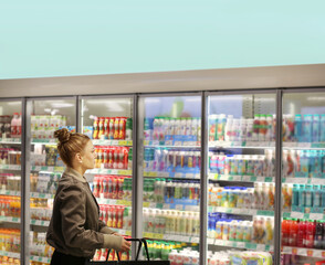 Woman choosing a dairy products at supermarket