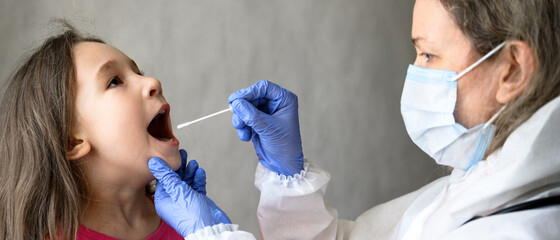 Kid opens mouth for COVID-19 PCR test, doctor holds swab for saliva sample from little girl