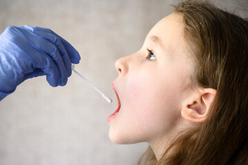 Child opens mouth for COVID-19 PCR test, kid and swab for saliva sample