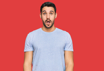 Obraz premium Young hispanic man wearing casual clothes afraid and shocked with surprise and amazed expression, fear and excited face.