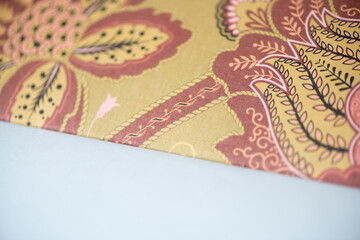 floral patterned scrapbooking paper photographed using a macro lens, featuring a shallow depth of field