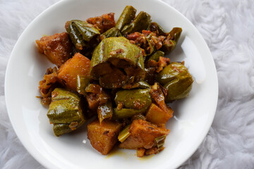 Parwal aloo ki sabji also known as Pointed gourd and potato fry curry. Tasty home made side dish made dhaba style it is authentic Indian curry