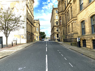 View along, Chapel Street, with Victorian stone buildings, built for the textile trade in, Little Germany, Bradford, UK