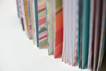 fancy scrapbooking paper (standing or vertically placed) photographed using a macro lens, featuring a shallow depth of field