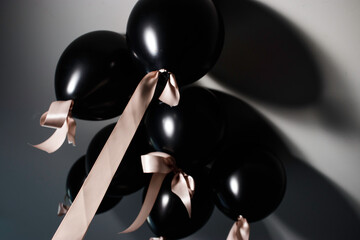 Black balloons with gold ribbon
