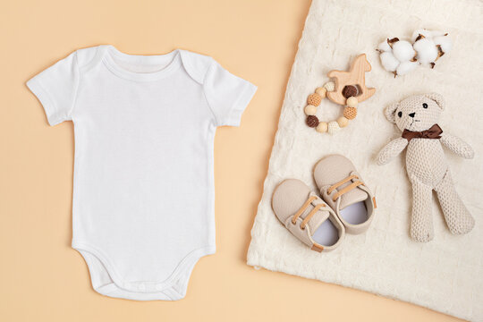 Mockup Of White Infant Bodysuit Made Of Organic Cotton With Eco Friendly Baby Accessories.  Onesie Template For Brand, Logo, Advertising. Flat Lay, Top View