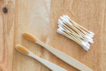 environmentally friendly bamboo and cotton cotton buds on a pink background, bamboo toothbrushes for adults and children. human personal hygiene products without harming the environment, biodegradable