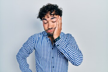 Young hispanic man wearing casual clothes thinking looking tired and bored with depression problems with crossed arms.
