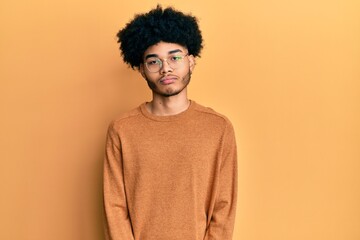 Fototapeta na wymiar Young african american man with afro hair wearing casual winter sweater depressed and worry for distress, crying angry and afraid. sad expression.