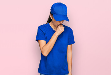 Young hispanic girl wearing delivery courier uniform feeling unwell and coughing as symptom for cold or bronchitis. health care concept.