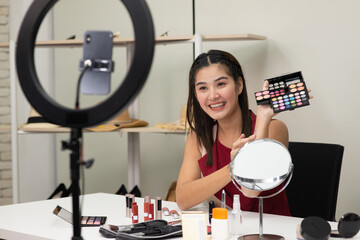 Beautiful Asian woman beauty makeup artist vlogger explain beauty cosmetic product on social media...