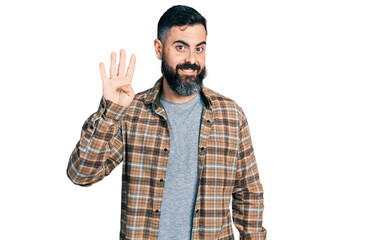 Naklejka premium Hispanic man with beard wearing casual shirt showing and pointing up with fingers number four while smiling confident and happy.
