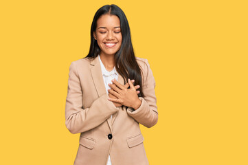 Beautiful hispanic woman wearing business jacket smiling with hands on chest with closed eyes and grateful gesture on face. health concept.