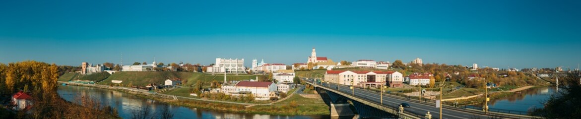 Fototapeta na wymiar Grodno, Belarus. Grodno Regional Drama Theater And Catholic Church Of Discovery Of Holy Cross And Bernardine Monastery In Sunny Autumn Day. Panorama, Panoramic View. Skyline Cityscape