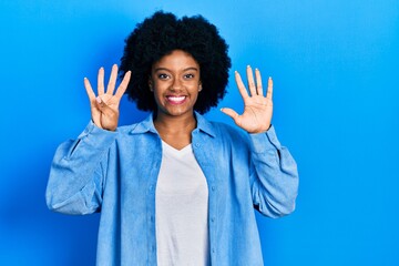 Young african american woman wearing casual clothes showing and pointing up with fingers number...