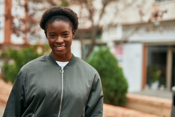 Young african american girl smiling happy standing at the city.