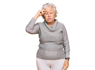 Senior grey-haired woman wearing casual winter sweater worried and stressed about a problem with hand on forehead, nervous and anxious for crisis