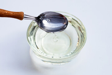 Sugar syrup in glass bowl on white