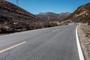 An open road under a snowy mountain