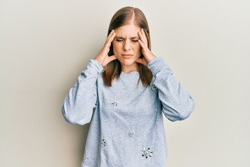 Beautiful caucasian woman wearing casual clothes suffering from headache desperate and stressed because pain and migraine. hands on head.