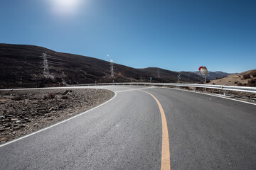 An open road under a snowy mountain