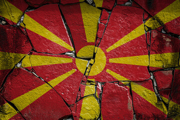 National flag of Macedonia depicting in paint colors on an old stone wall. Flag  banner on broken ...