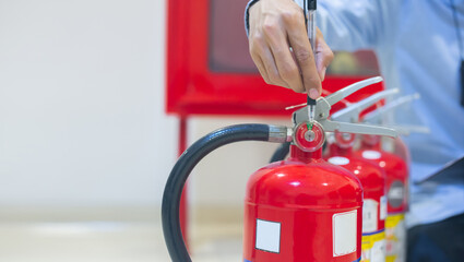 Expert engineers inspect fire extinguishers to be ready for use.