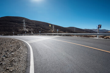 An open road under a snowy mountain